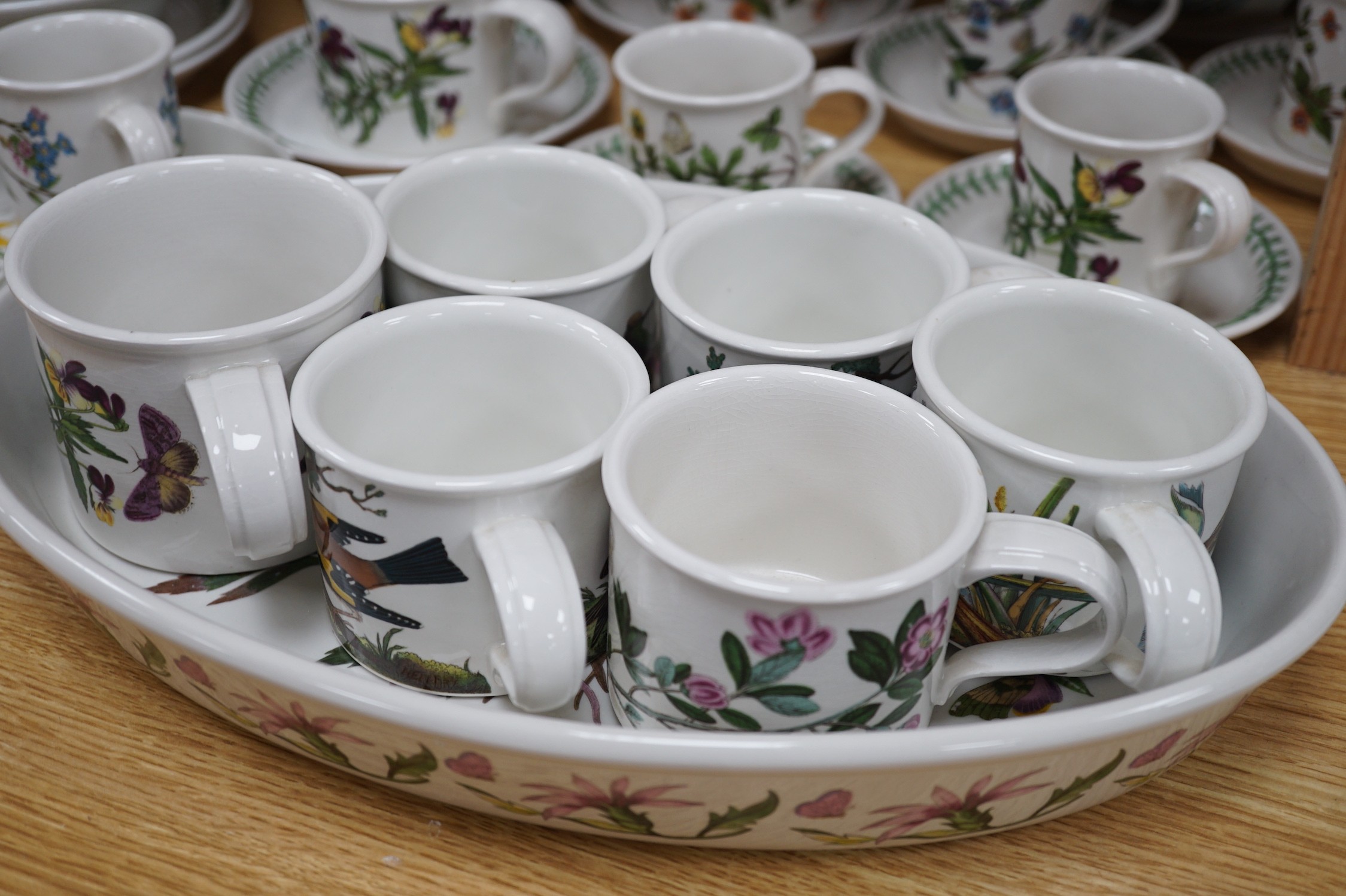 A mixed Portmerion dinner service- a biscuit jar and cover, tureens, serving dishes, teapot etc